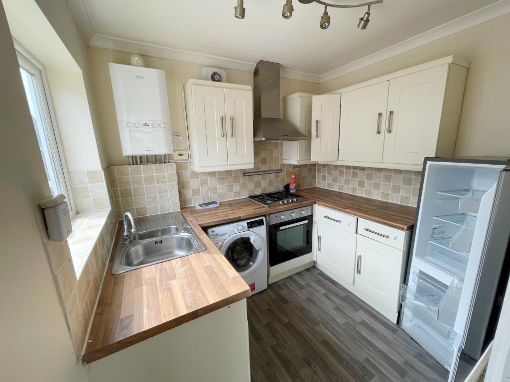 Lot: 10 - TWO-BEDROOM MAISONETTE - Cream kitchen with wooden effect worktops